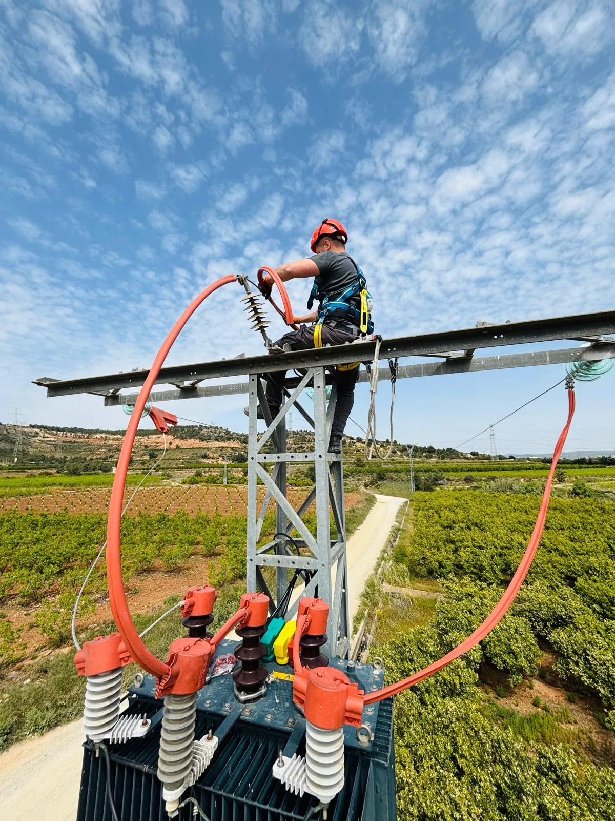 Técnico eléctrico de OLMELECTRIC en apoyo de alta tensión con equipo de seguridad en Valencia